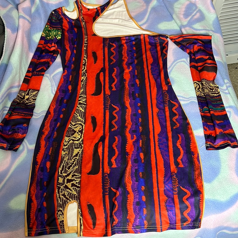 Cute asymmetrical clubbing dress never worn in great shape polyester material